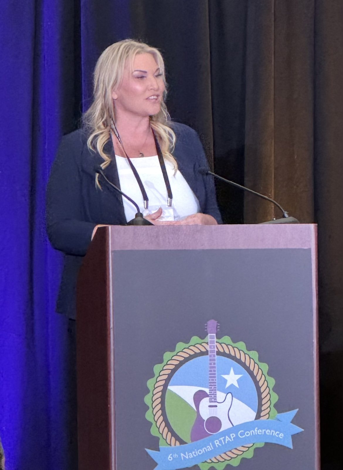 Michelle Robertson of Grand Splash Marketing speaking at the podium of the National RTAP Conference