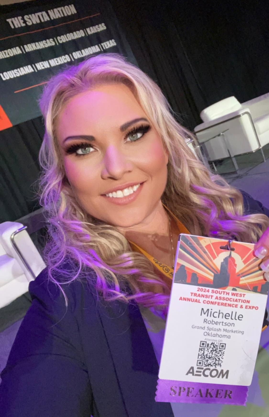Michelle Robertson holding her speaker badge at the 2024 South West Transit Association Annual Conference and Expo