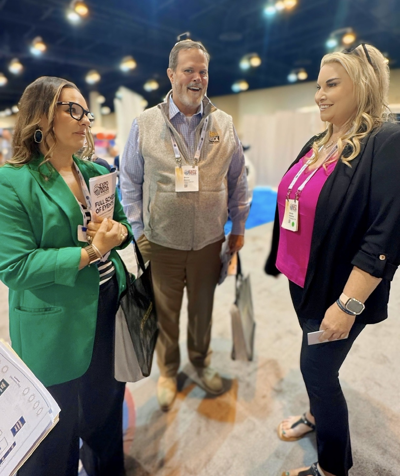 Michelle Robertson in conversation with transit industry leaders on a trade show floor
