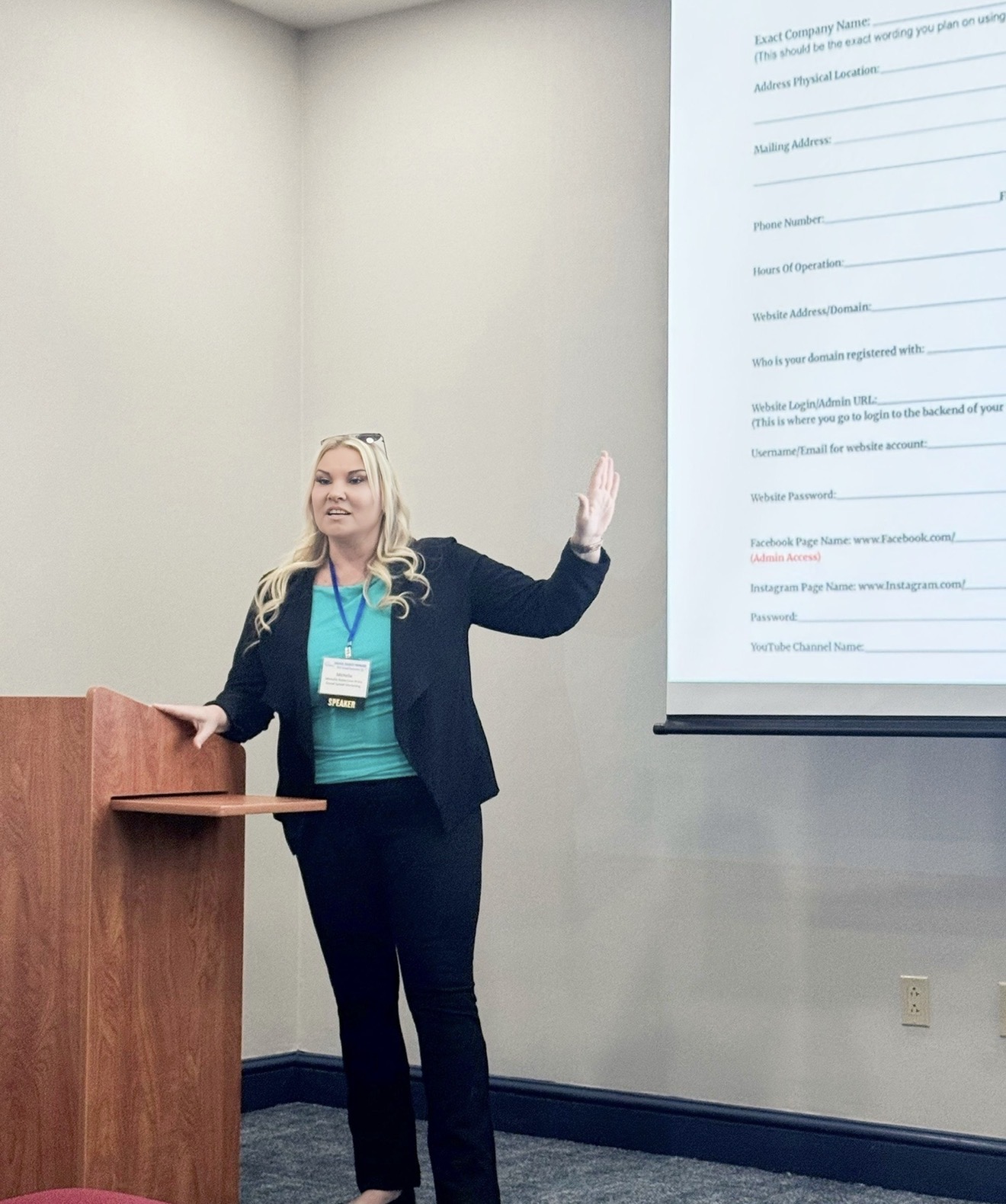 Michelle Robertson presenting a marketing training session beside a projected worksheet